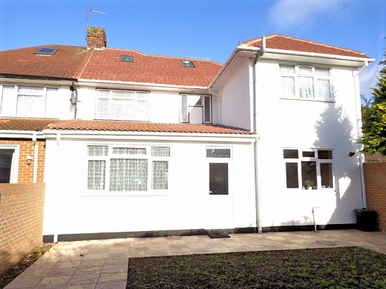 Newly painted house exterior with new guttering.